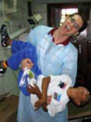 dentist holding child and laughing