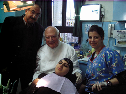 Volunteer dentist treating patient in Israel clinic