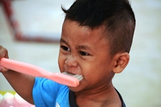 Boy with large toothbrush