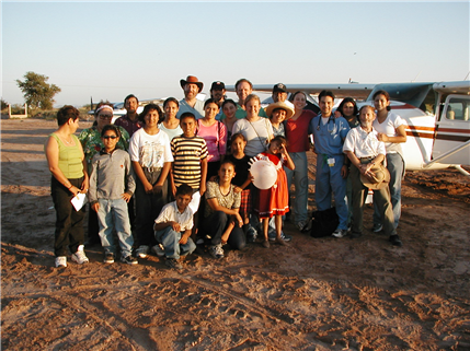 Group of volunteers outside plane