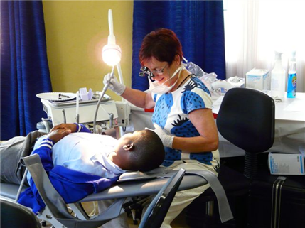 Dentist treating boy in chair