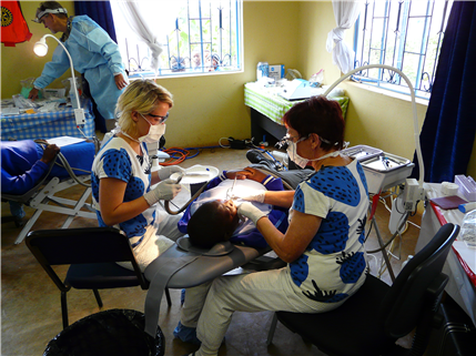 Dental Staff treating patient lying in chair