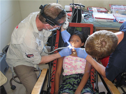 two dentists treating young girl