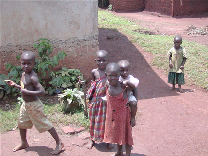 Photo of five children playing on hard packed red dirt