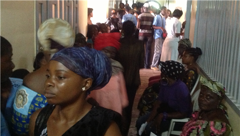 Photo of adults in colorful clothing in a hallway