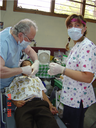 Photo of two volunteers providing care to a child in a clinic