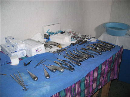 Photo of dental instruments lined up on a blue cloth in a clinc
