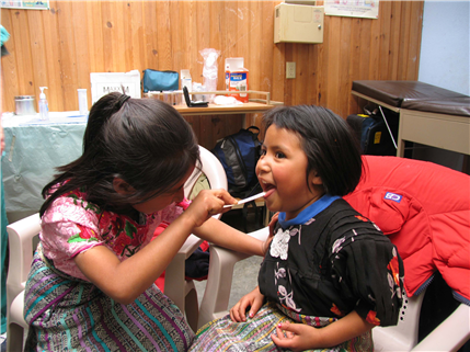 Photo of two children playing dentist in a dental clinic