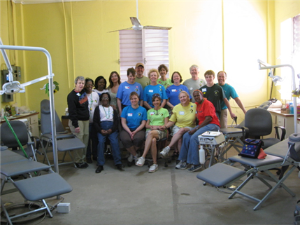 Photo of a group of seventeen dental volunteers in a quiet clinic