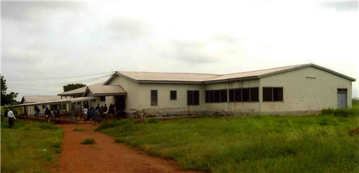 Exterior of a single story building with people in front