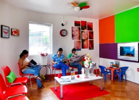 Photo of three people in a colorful waiting room