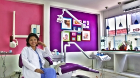 Photo of a colorful dental clinic with a dental team member in a seated pose