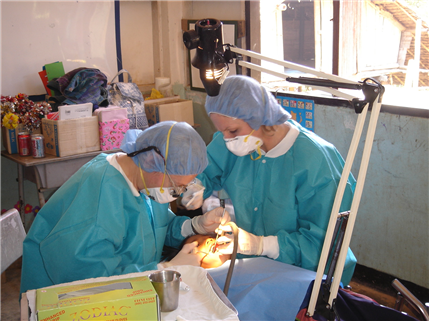 A child receives oral health treatment at a clinic with sun shining through the window