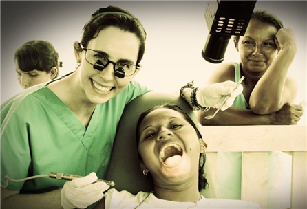 Photo of dental caregiver and smiling child saying "aaah"