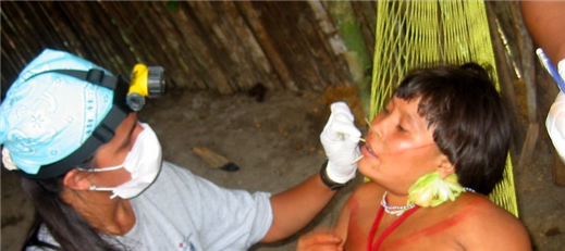 Photo of a dental volunteer with a patient in a tribal setting