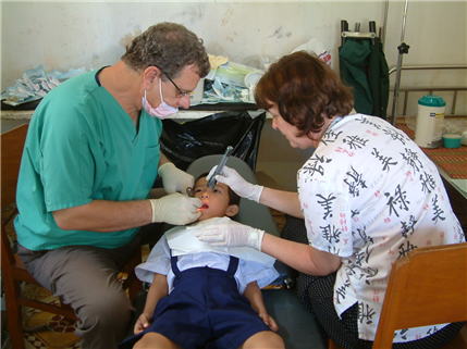Photo of a dental team providing care to a small child in a clinic