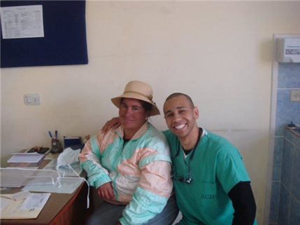 Two adults smile and pose in a dental clinic