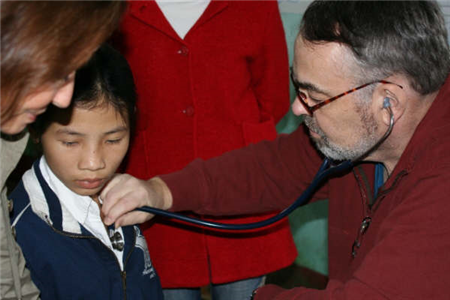 Photo of doctor listening to a child's chest with a stethoscope