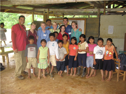 Group photo of a group of adult medical professionals and kids
