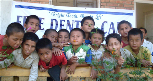 Photo of 12 kids in front of a VOLNEPAL banner